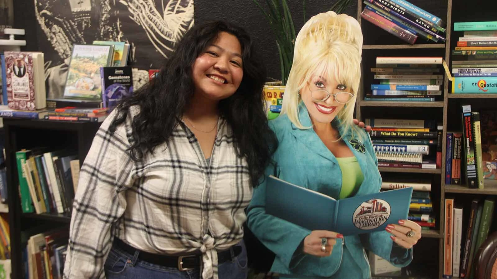 Kaylen Kidney, Natrona County’s Dolly Parton Imagination Library coordinator, poses with a Dolly cutout in the bookstore.