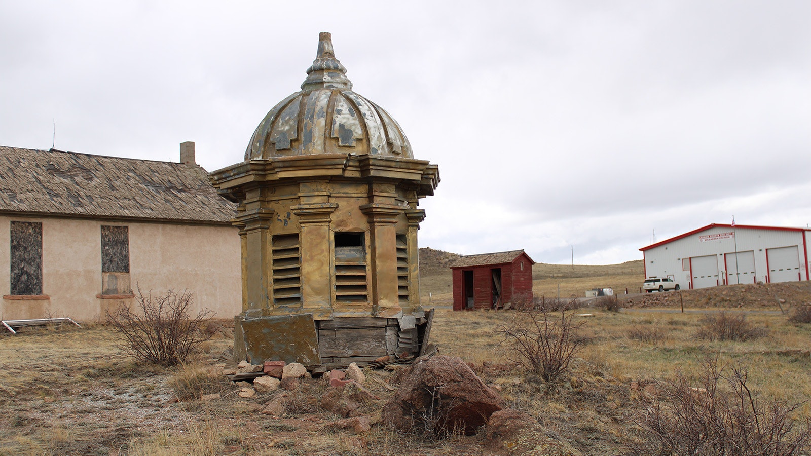 One of two original 1917 Wyoming Capitol domes sits in on property west of Cheyenne near an old one-room schoolhouse.