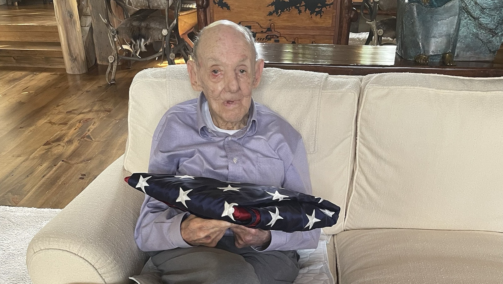 Donald Siegel with a flag that was flown over the U.S. Capitol in his honor for his service during World War II.