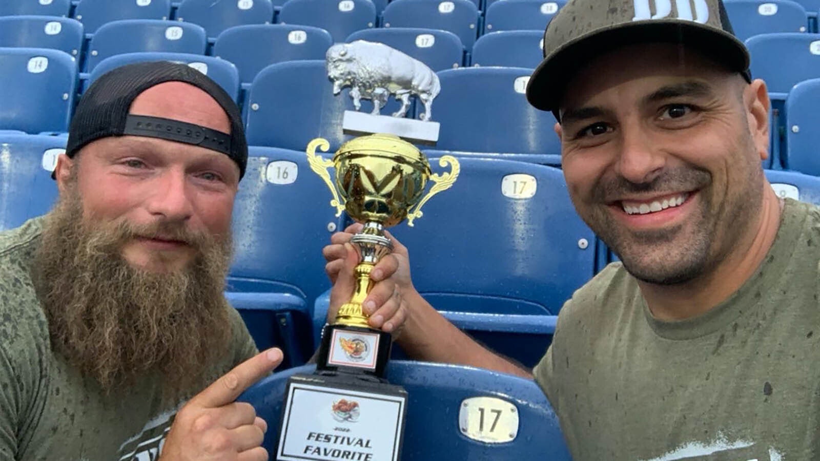 Trent Weitzel, left, and Dallas Lopez hoist the Festival Favorite trophy at the National Buffalo Wing Festival in Buffalo, New York.