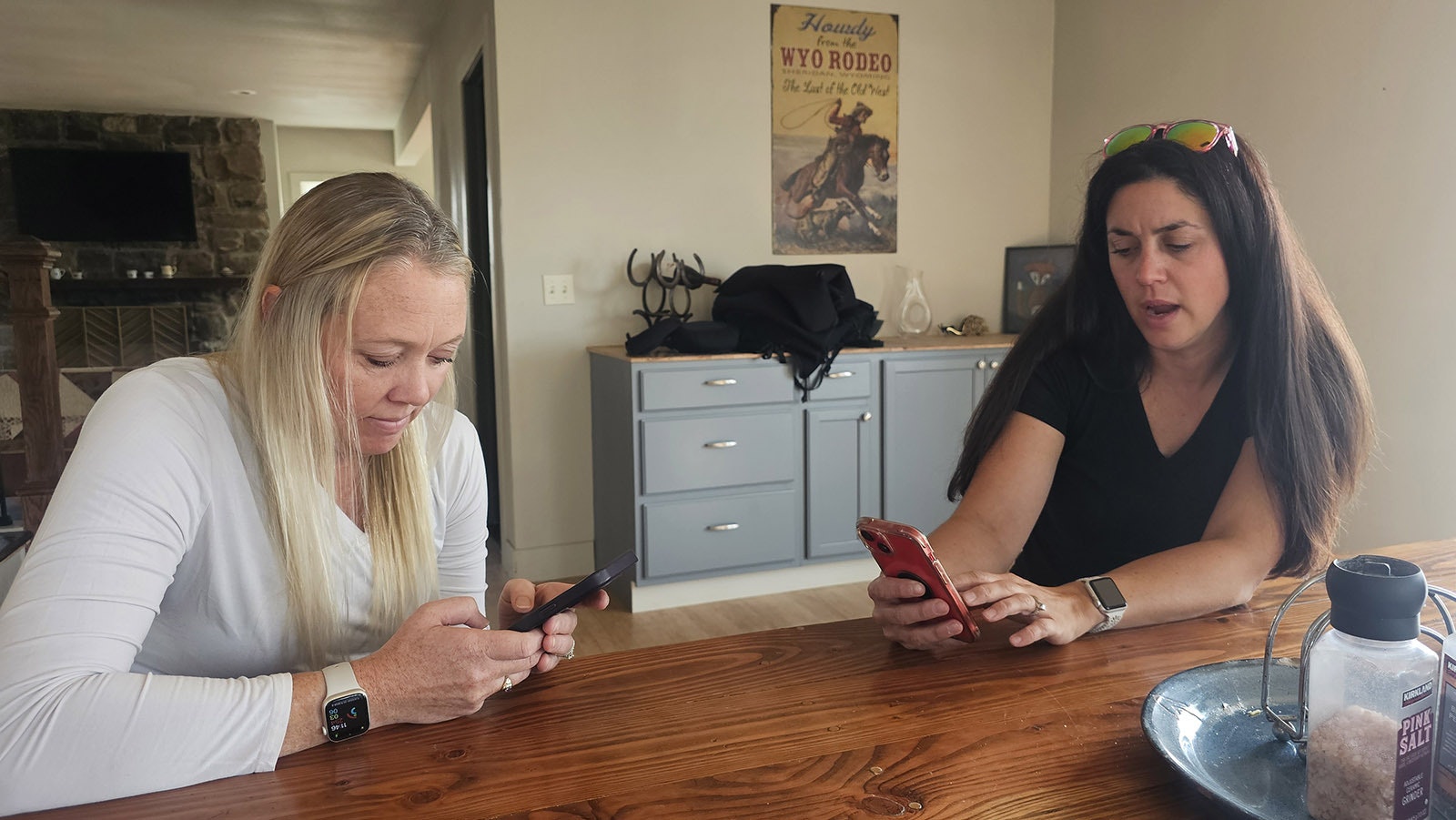 Chelsie Warner, left, and Jill Kerns, right, look for photos of the Elk Fire, which almost consumed the Double Rafter Ranch.