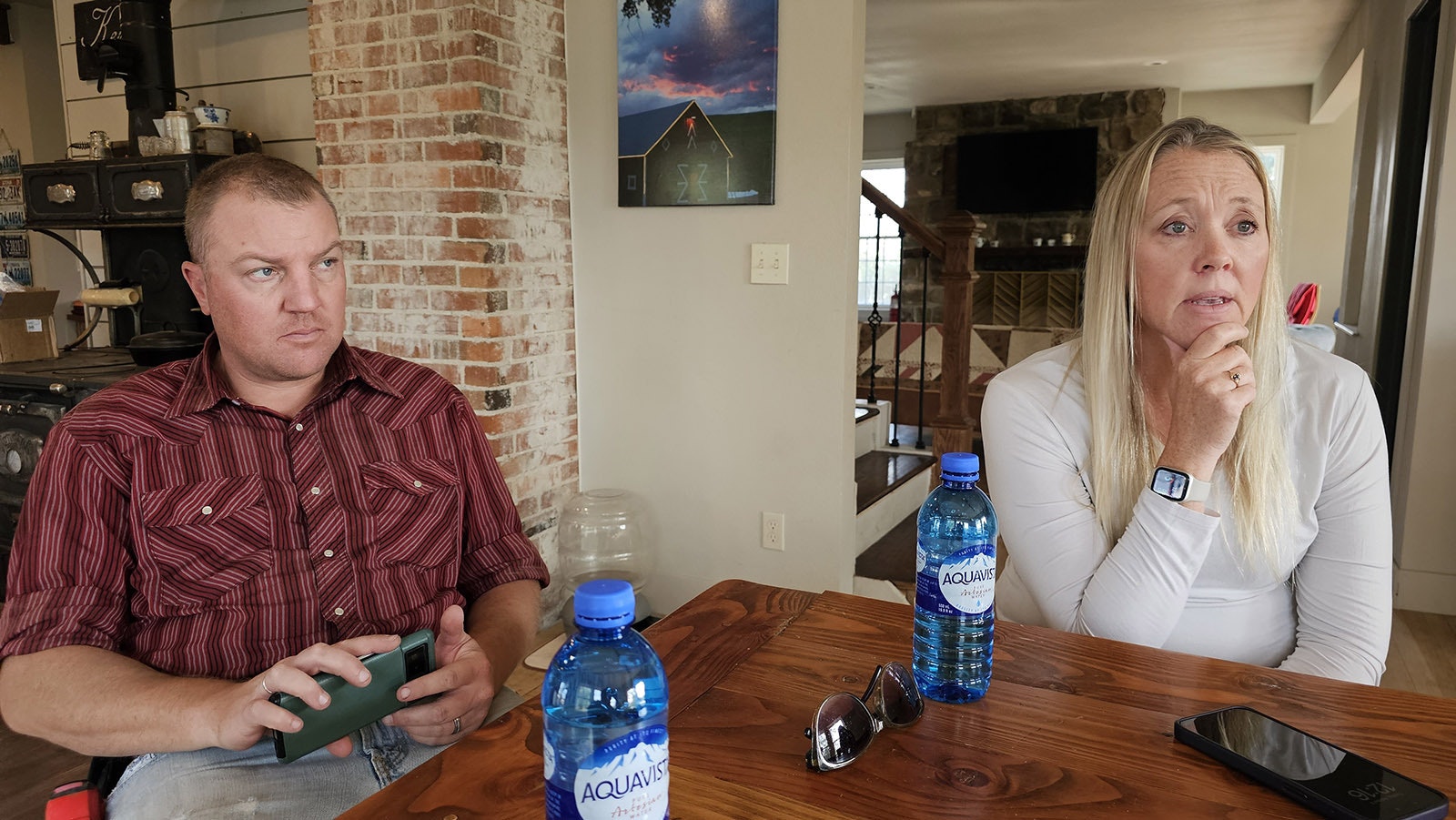 Marcus, left, and Chelsie Warner talk about the Elk Fire that almost consumed the Double Rafter Ranch north of Parkman, Wyoming.