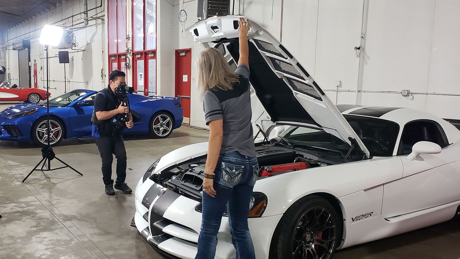 Desiree Hannabach shows her 2010 Viper to a crew filming for a nationally television show during last weekend's Cars, Guitars and Cigars show in Cheyenne.