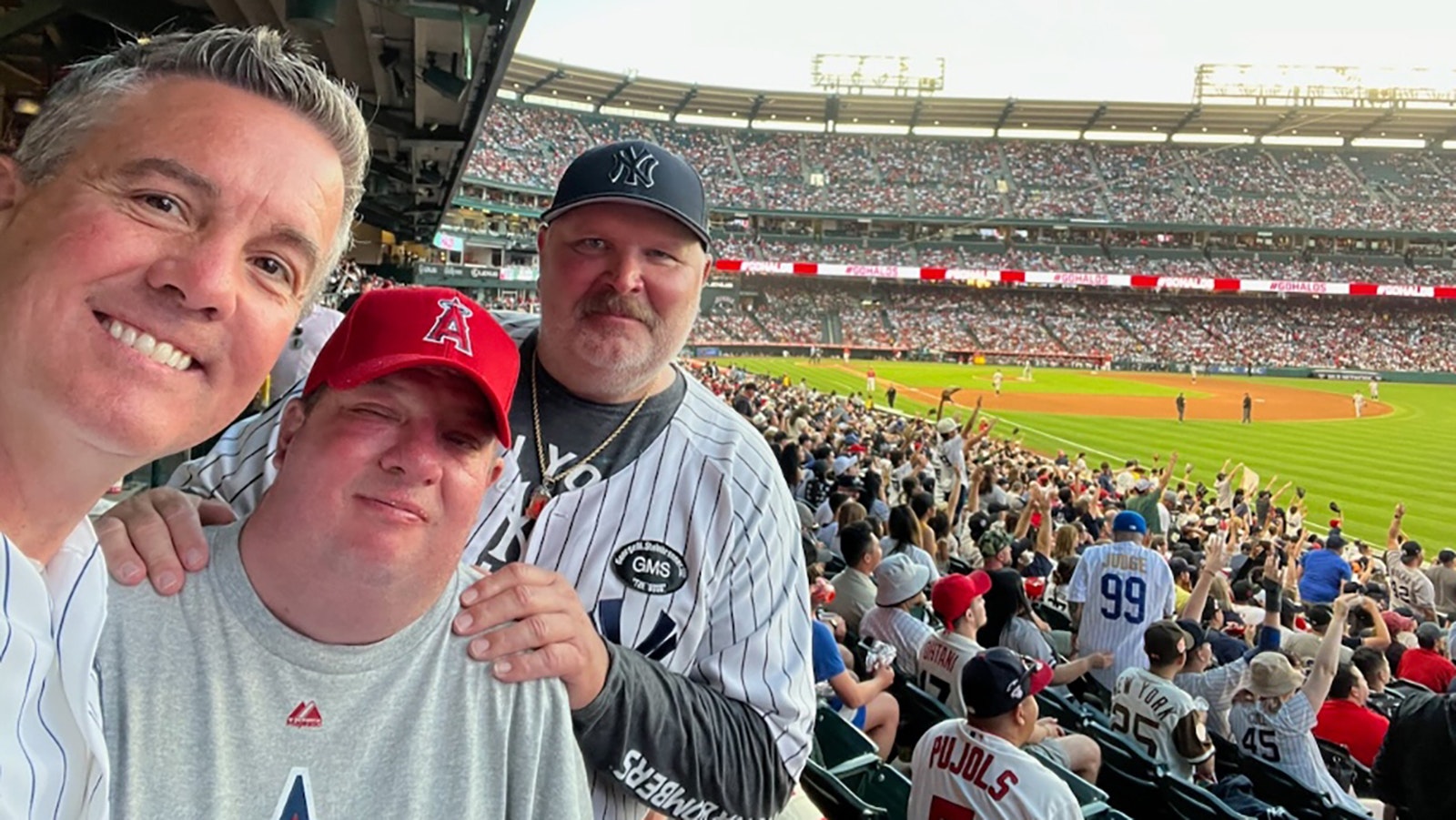 Dreams in Motion honored Lance Beckert, right, of Utah in July 2023 when the Yankees played the Angels in California. He is pictured with co-founders Joel Brown, left, and Bruce Tippets.