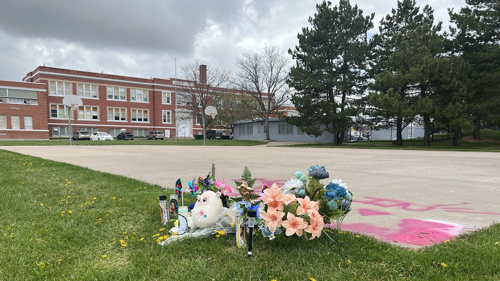 A memorial for a 15-year-old girl shot and killed in a drive-by at Lincoln Park in Cheyenne. Two teens have been charged as adults in the killing.