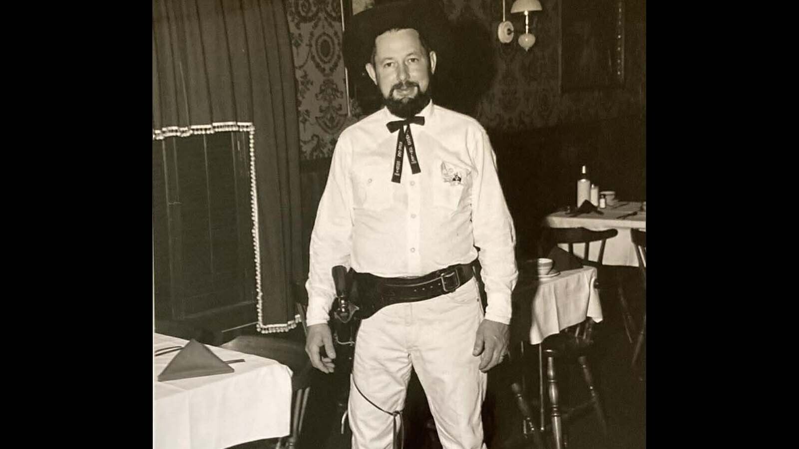 Ed Brantz, one of the founders of the Dry Gulchers, models his western uniform, complete with the customized black tie and revolver.