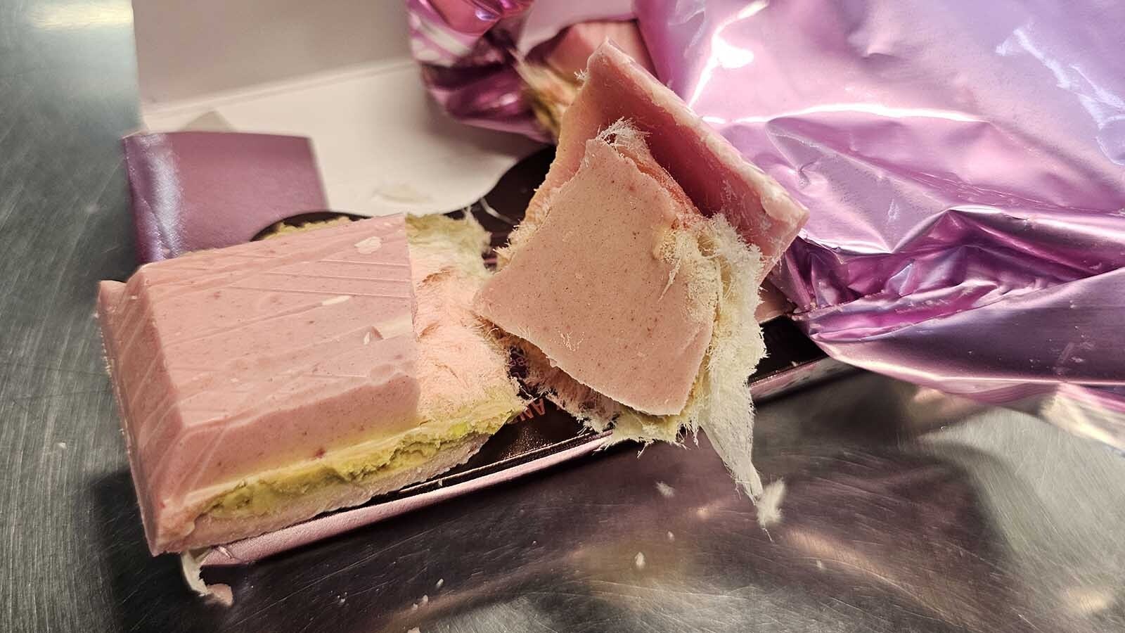 A Dubai chocolate bar is a creamy layer of pistachio butter with shredded phyllo dough enrobed in chocolate. It's sometimes flavored with things like saffron, tahini and rosewater flavored syrup. In this case, the bar had raspberry flavoring instead