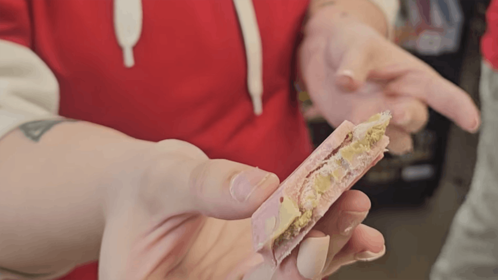 A Dubai chocolate bar is a creamy layer of pistachio butter with shredded phyllo dough enrobed in chocolate. It's sometimes flavored with things like saffron, tahini and rosewater flavored syrup. In this case, the bar had raspberry flavoring instead