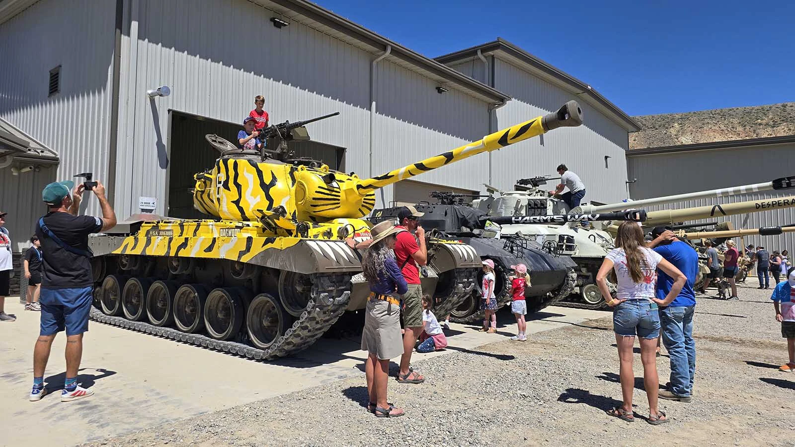 Before the parade begins, the tanks in the parade are staged at Dan Starks' restoration shop. People are invited to climb in the tanks and can even get free rides in a tank.