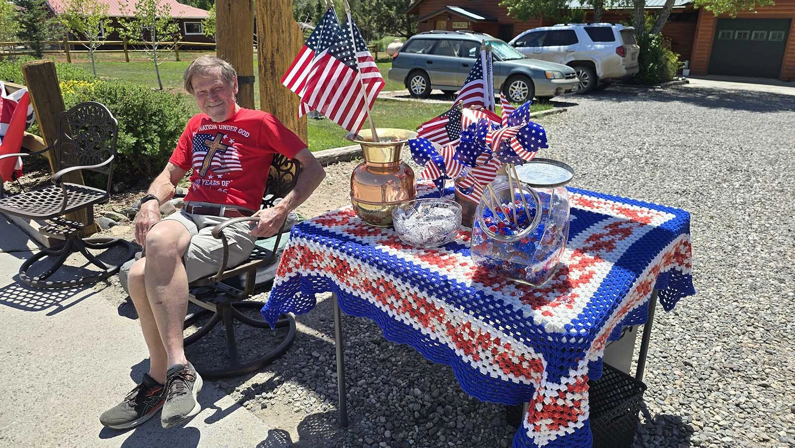Steve Burgess, Dubois, offered flags and pinwheels, as well as mints, to people gathered in Dubois for its Fourth of July parade.