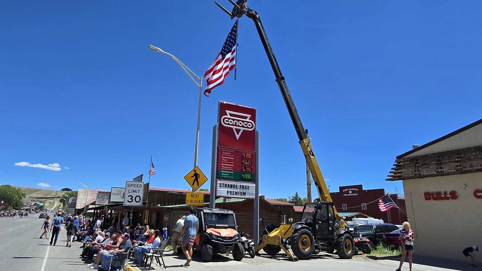 A huge flag was hoisted up on a crane over the streets of Dubois on Saturday, where a crowd of thousands awaited the tiny mountain town's signature military tank parade.