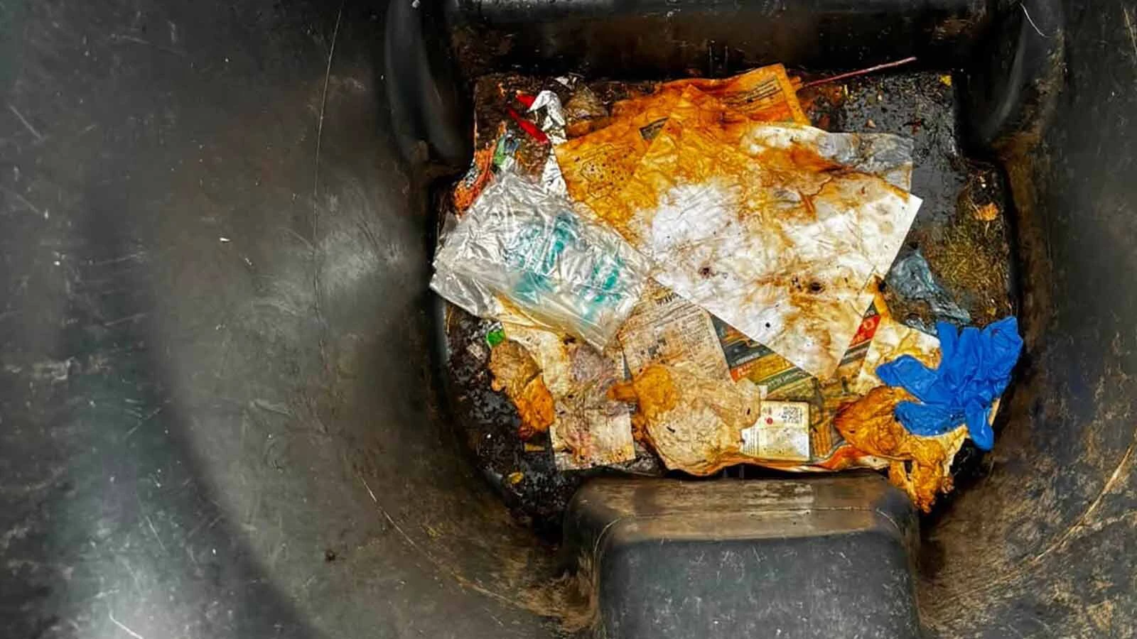 Trash and grime cling to the bottom of a Cheyenne garbage bin before Michael Addleman of 307 Bin Cleaning gets to work. 