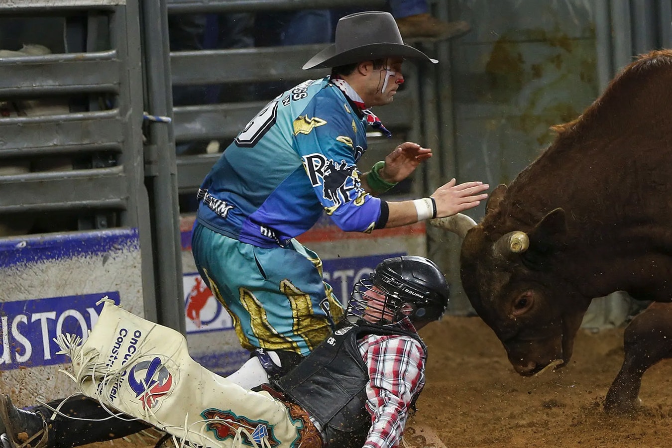 Bullfighter Dusty Tuckness fights off a bull named Hangover as he tries to protect Brennon Eldred after he was thrown during the bull riding competition during the Houston Livestock Show and Rodeo at NRG Stadium on March 13, 2015, in Houston.