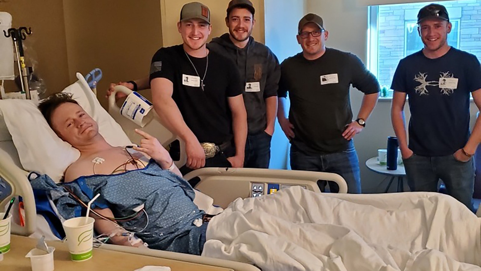 Dylan Schilt with his four brothers in a Colorado hospital after Schilt, a Laramie firefighter, was hurt when a burning house collapsed on him.