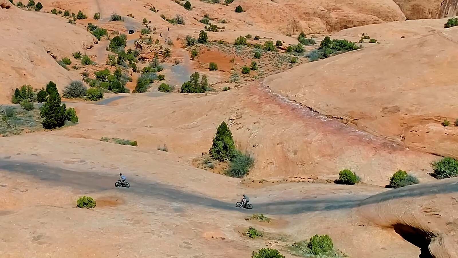 A pair of e-bike riders cruise through a section of Moab, Utah, trails.
