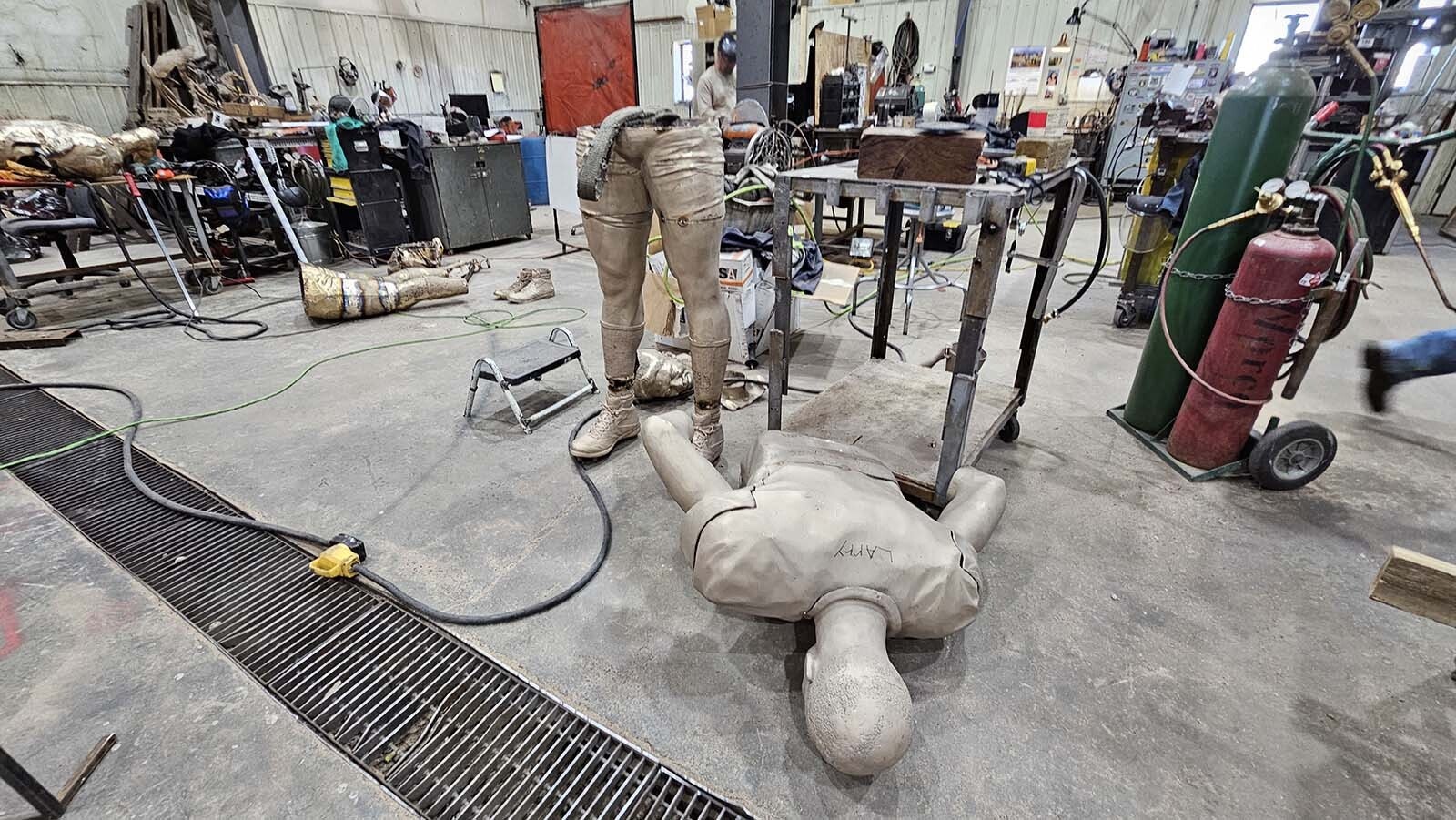 Pieces of a bronze statue are being put together in the shop at the Eagle Bronze foundry in Lander.