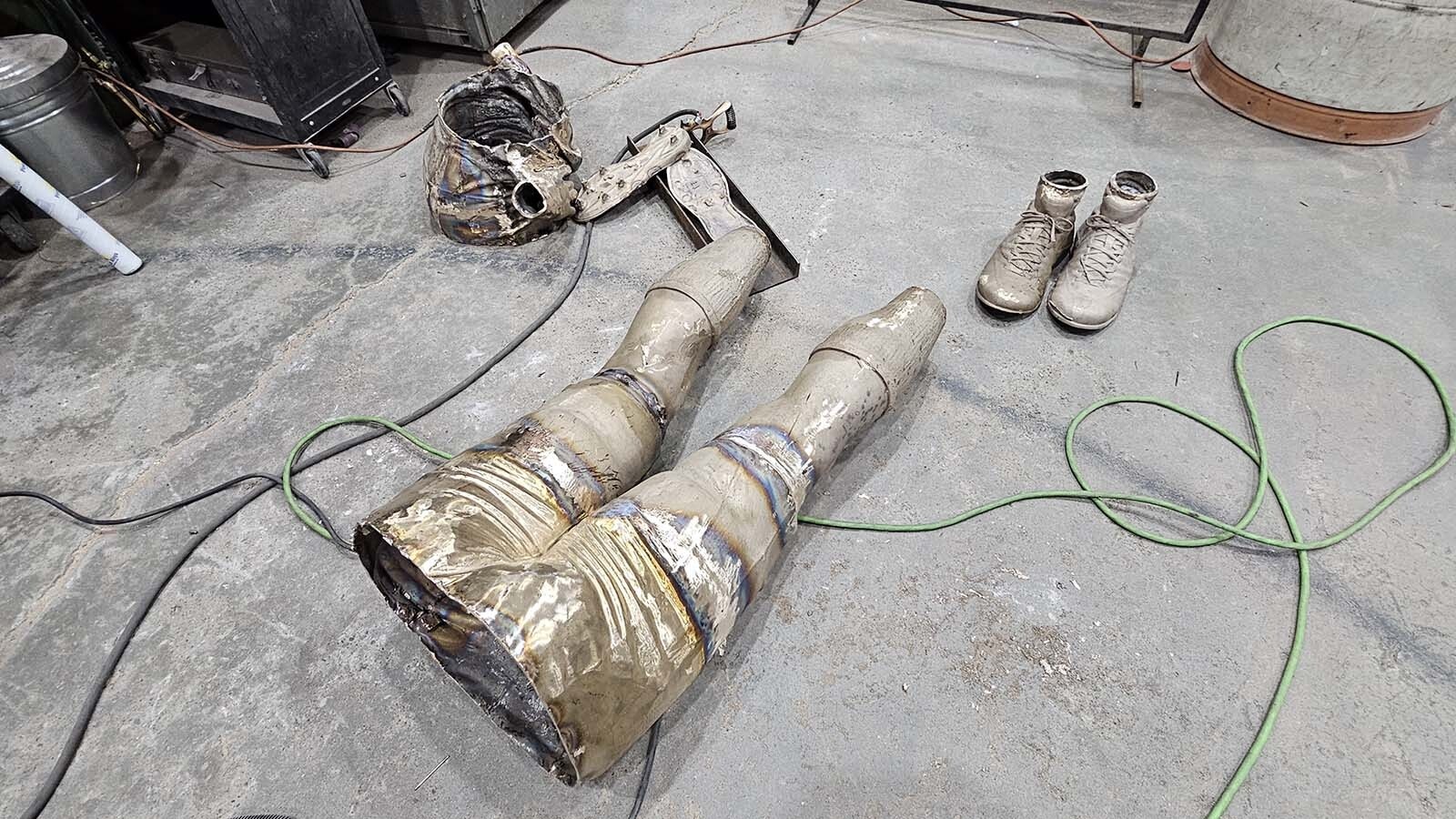 Pieces of a bronze statue are being put together in the shop at the Eagle Bronze foundry in Lander.