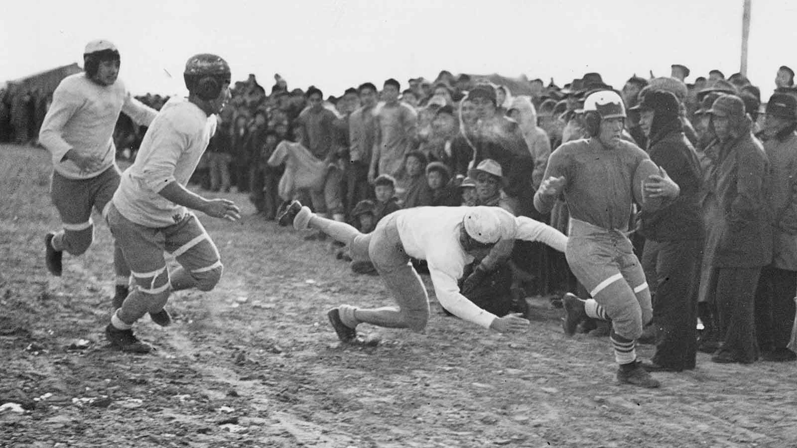 Babe Nomura, second from left, helps force Tosh Asano, right, out of bounds during an intracamp 1943 Thanksgiving game.