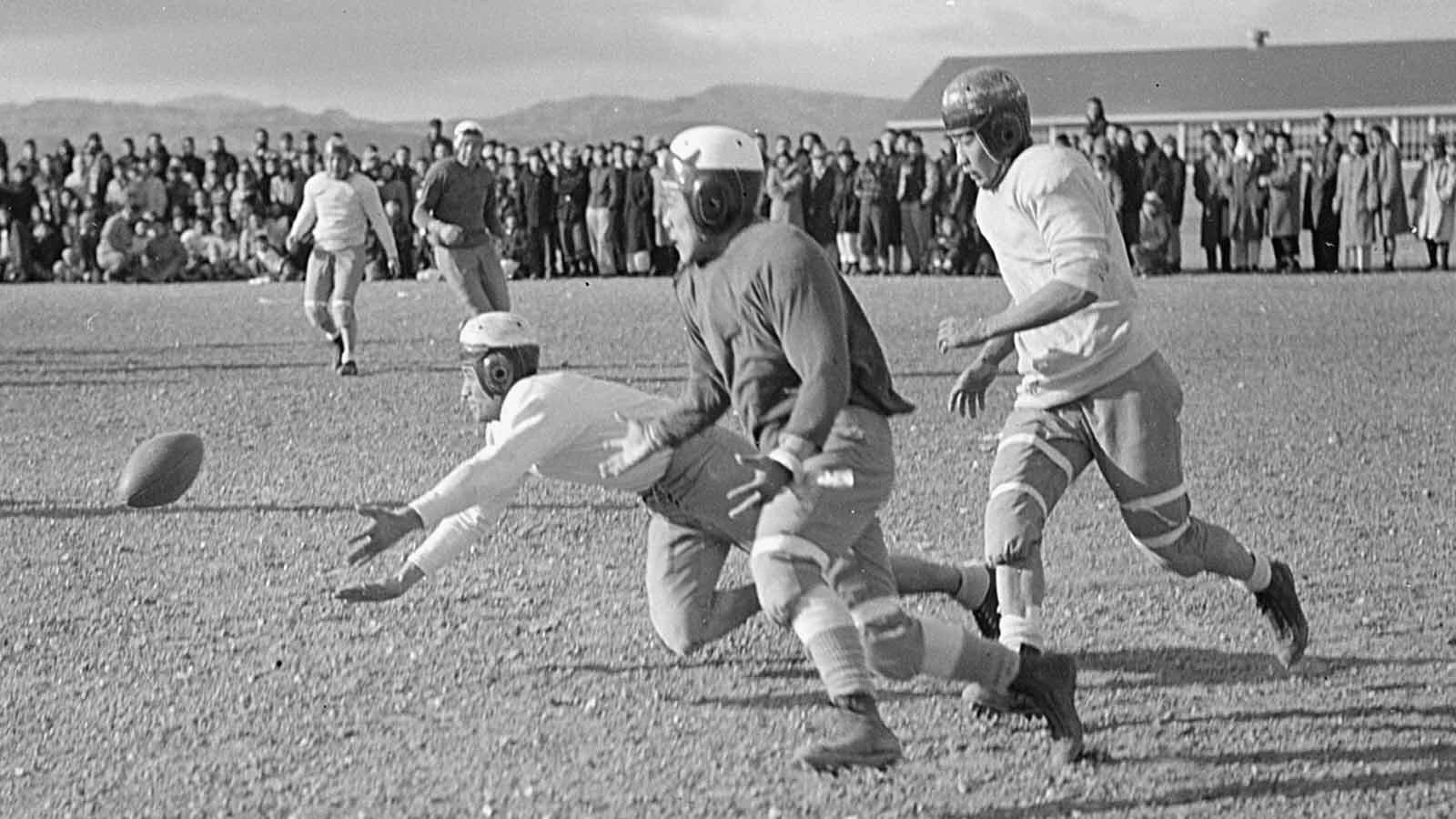 A player attempts to jump on a loose fumble on the Eagles' hardscrabble field.