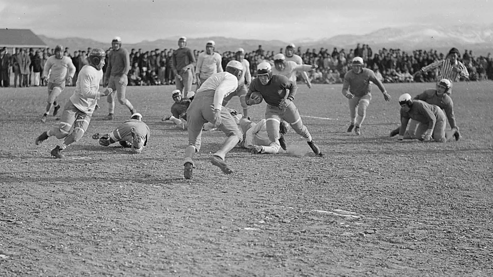 Tosh Asano carries the ball during an inter-camp game.