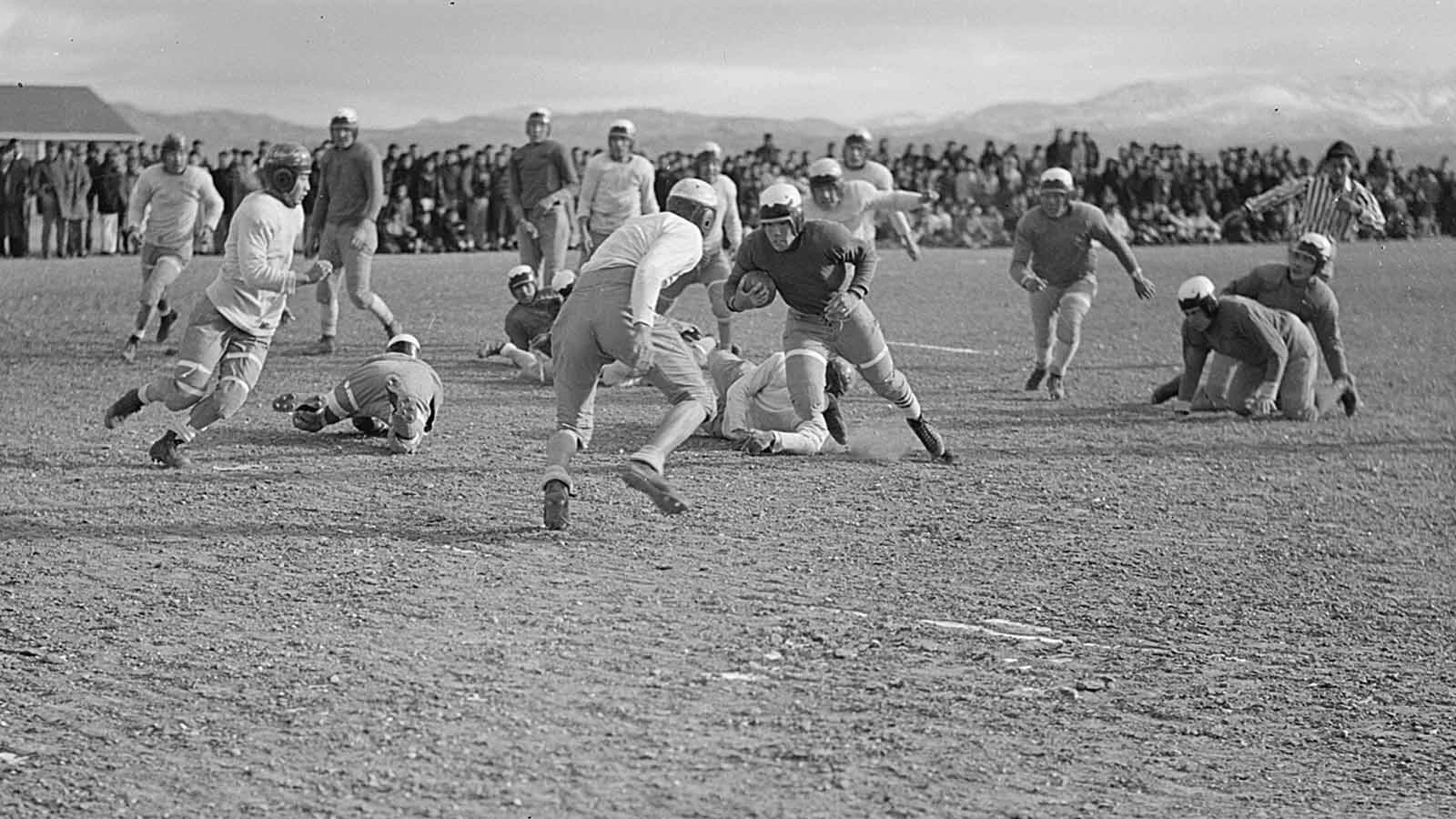 Tosh Asano carries the ball during an inter-camp game.