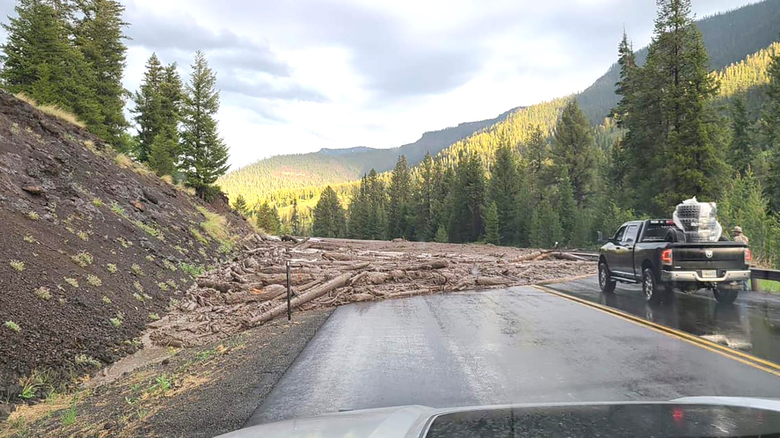 A mudslide spills out across Highway 14/16/20 just east of the Yellowstone East Gate on Tuesday.