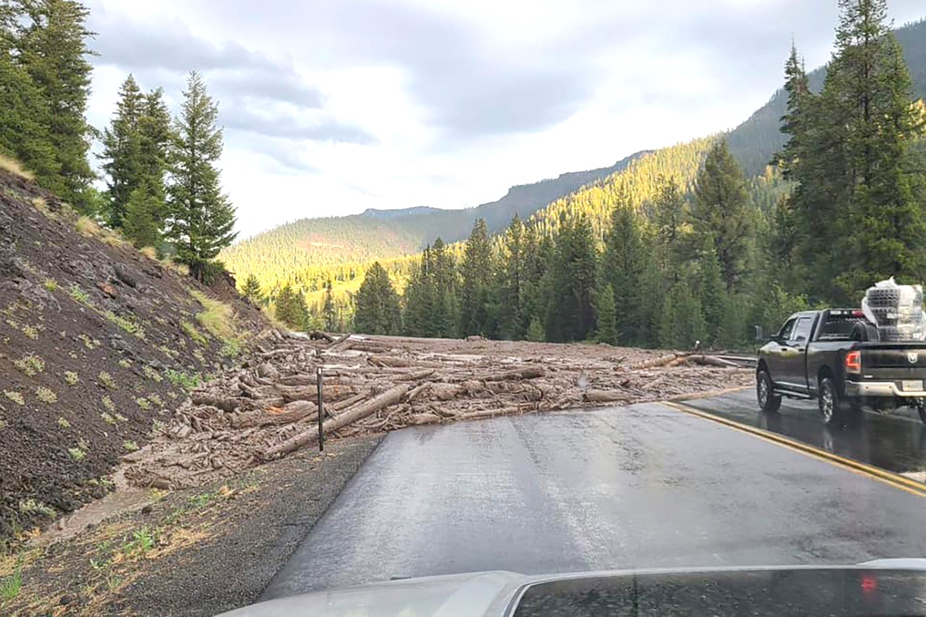 A mudslide spills out across Highway 14/16/20 just east of the Yellowstone East Gate on Tuesday.