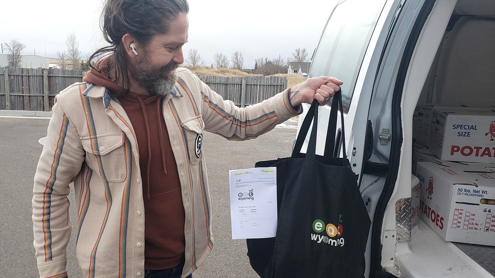 A driver for Eat Wyoming with a veggie bag.