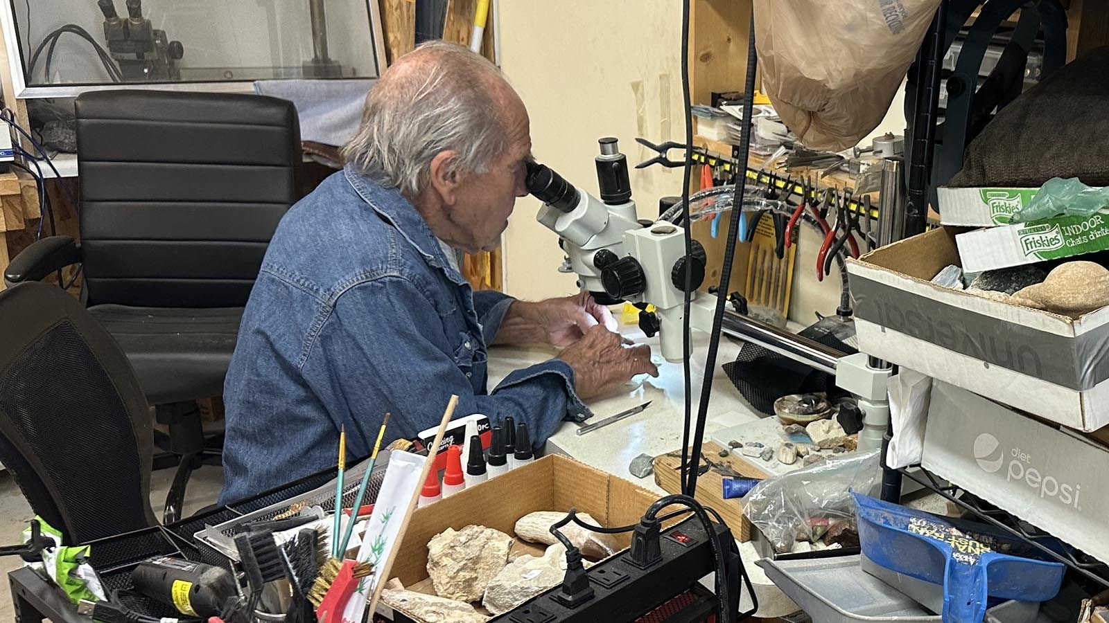 Eddy Cole uses a microscope when he is doing the finer work on polishing rocks. He also repairs watches in his workshop in Thermopolis, Wyoming located behind Ava’s Silver and Rock Shop.