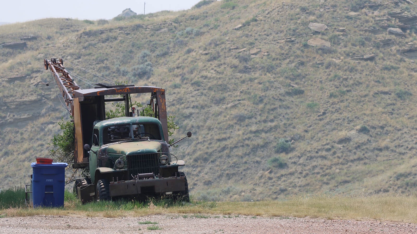 An old truck sits beside a residence at the end of town, its oil field glory long gone.