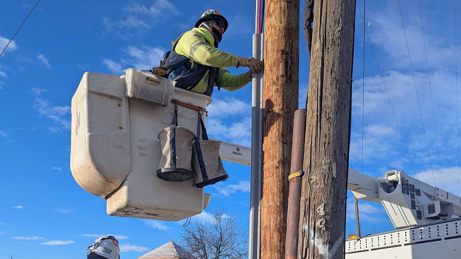 Chase Fisher installs a riser for new electrical service.