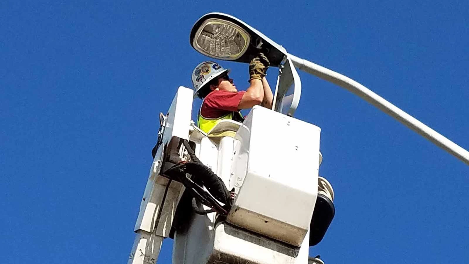 Robert Sandidge installs a new LED street light.