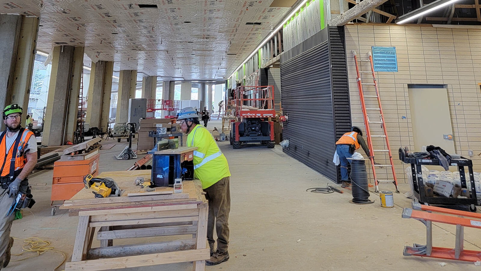 Brandon Schroyer,left, on the job at War Memorial Stadium in Laramie, where electricians are putting in new lighting.