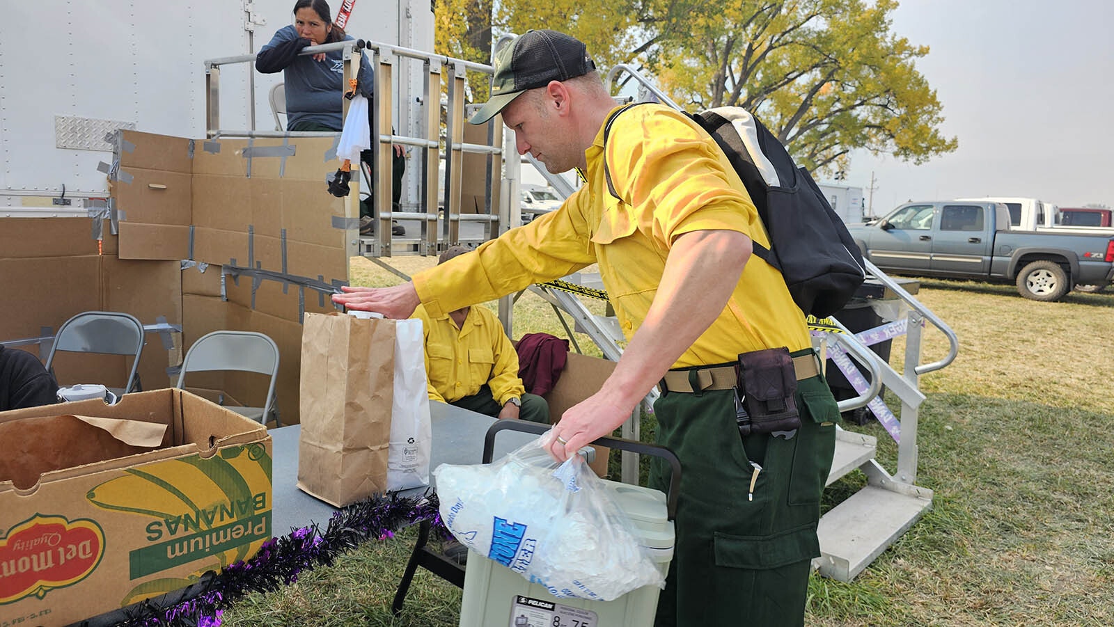 A firefighter picks up one of each type of lunch, vegetarian and non-vegetarian.