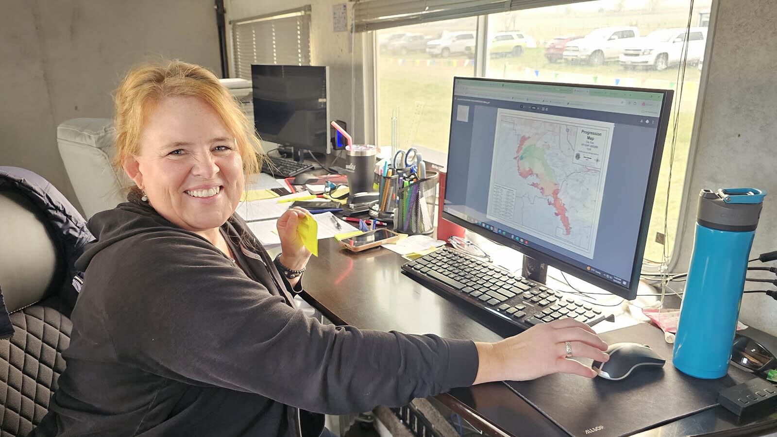 Janice Atwood works in the trailer where the daily Elk Fire maps are printed. She can print the maps in a range of sizes, from 8x10 sheets of paper to almost as tall as a semi-trailer.