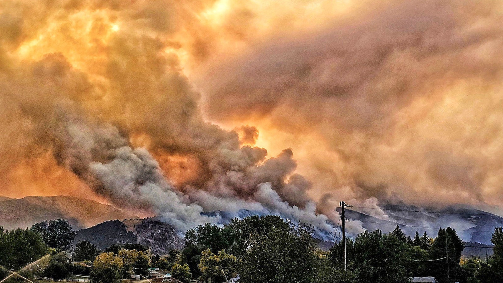 The small, rural Wyoming town of Dayton could only watch and pray as the Elk Fire burns across the mountain face of the Bighorns above in this October 2024 file photo.