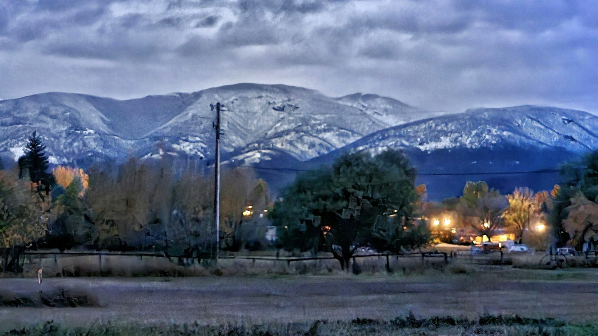 The face of the Bighorn Mountains over Dayton, Wyoming, are dusted with snow Friday, Oct. 18, 2024, a welcome sight from two weeks earlier when most of the mountain was glowing with a raging wildfire.