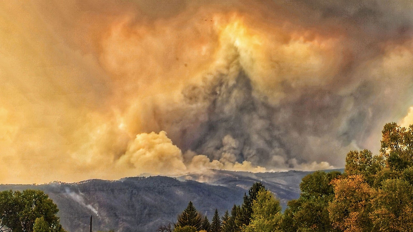 The small, rural Wyoming town of Dayton can only watch and pray as the Elk Fire burns across the mountain face of the Bighorns above.