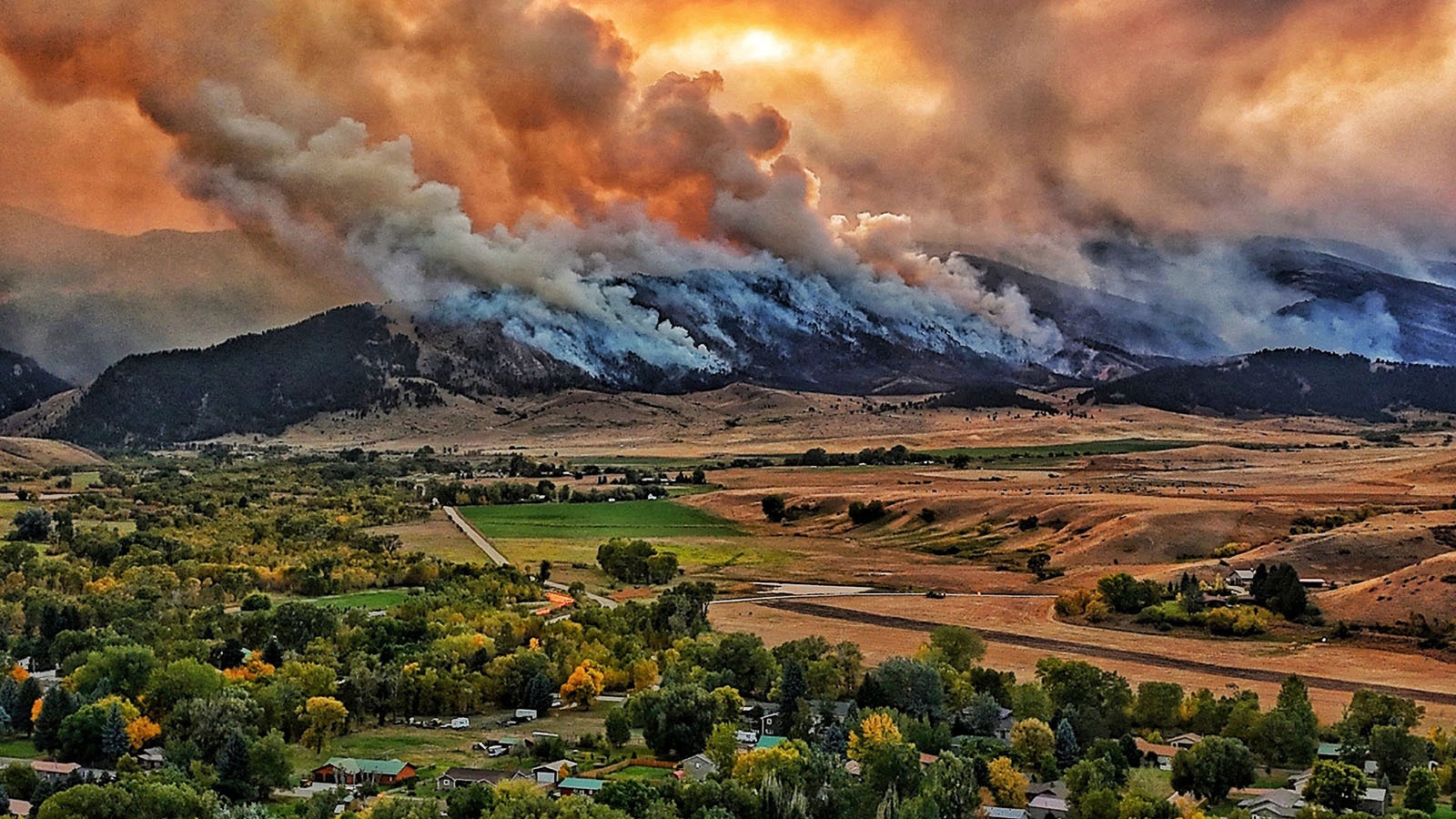 The small, rural Wyoming town of Dayton can only watch and pray as the Elk Fire burns across the mountain face of the Bighorns above.