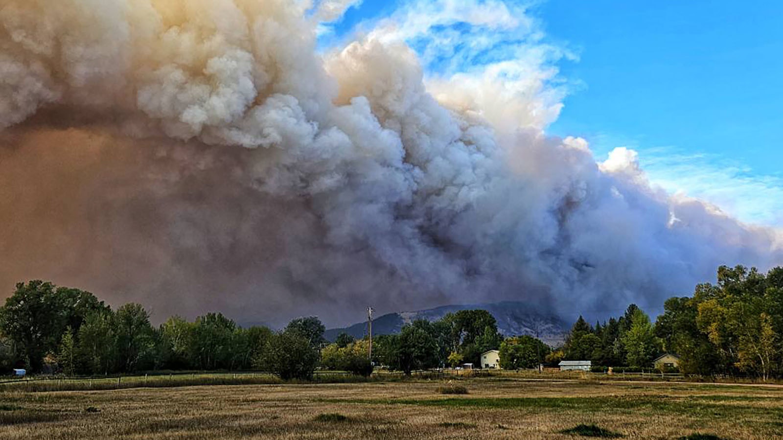 The small, rural Wyoming town of Dayton can only watch and pray as the Elk Fire burns across the mountain face of the Bighorns above.