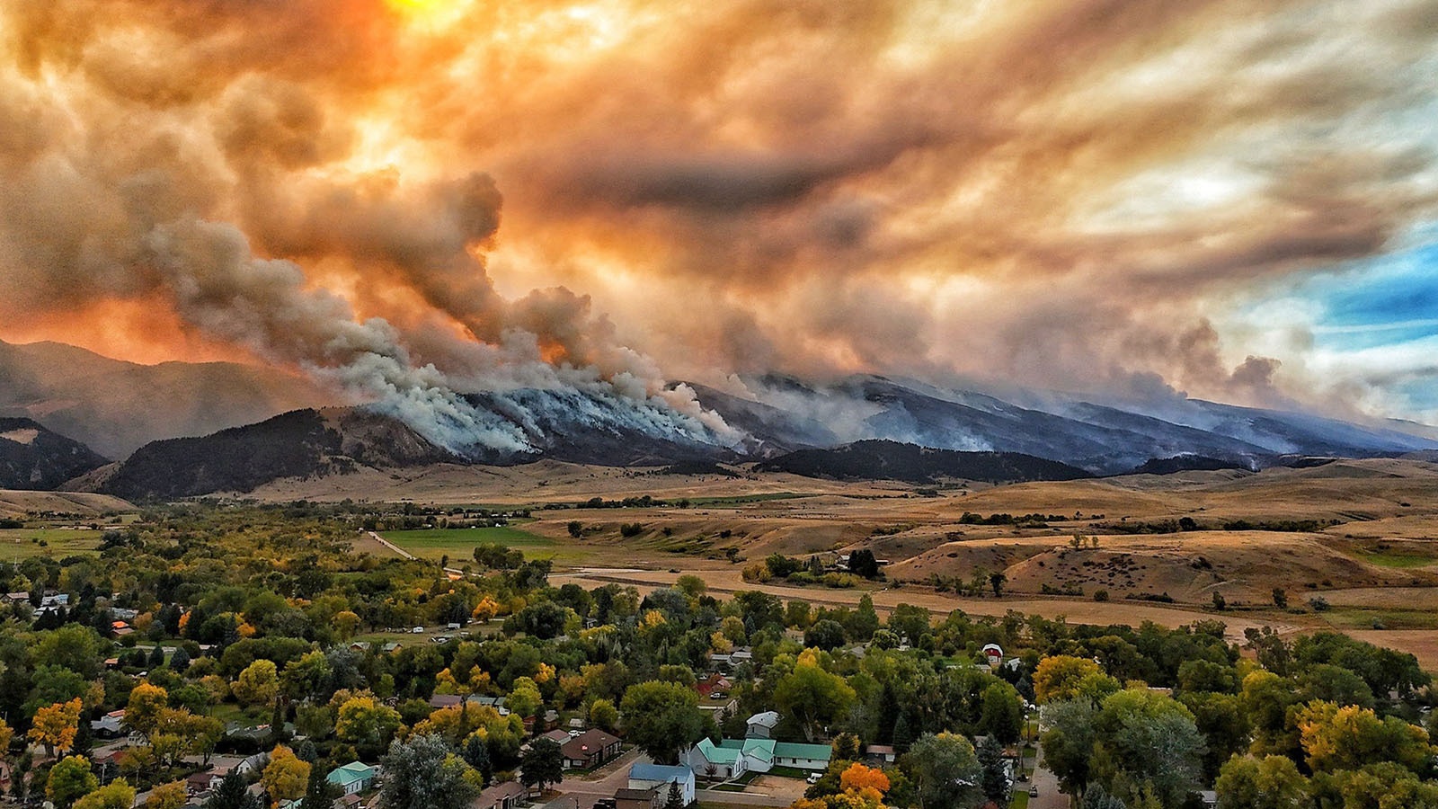 The small, rural Wyoming town of Dayton can only watch and pray as the Elk Fire burns across the mountain face of the Bighorns above.