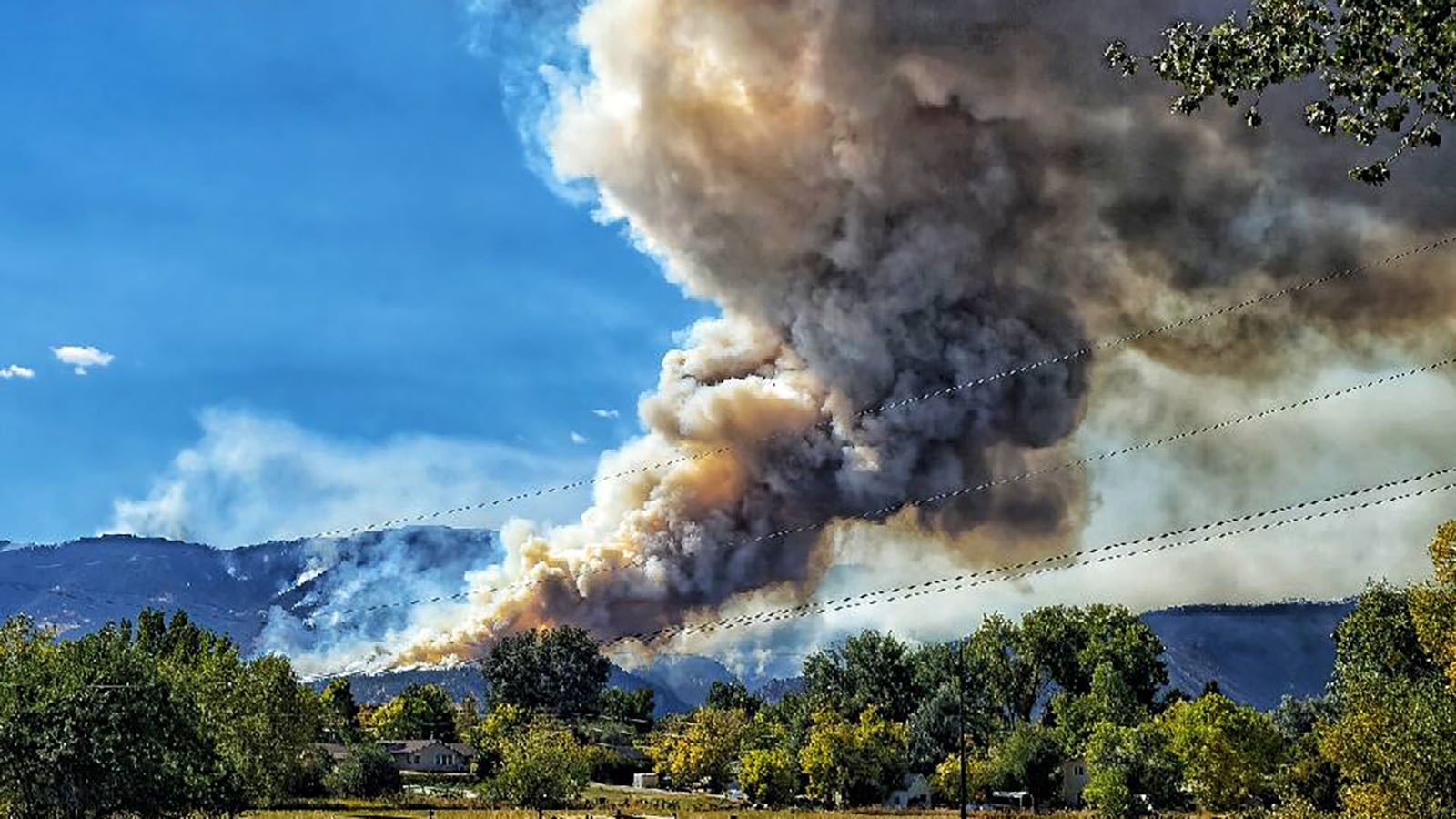 The small, rural Wyoming town of Dayton can only watch and pray as the Elk Fire burns across the mountain face of the Bighorns above.