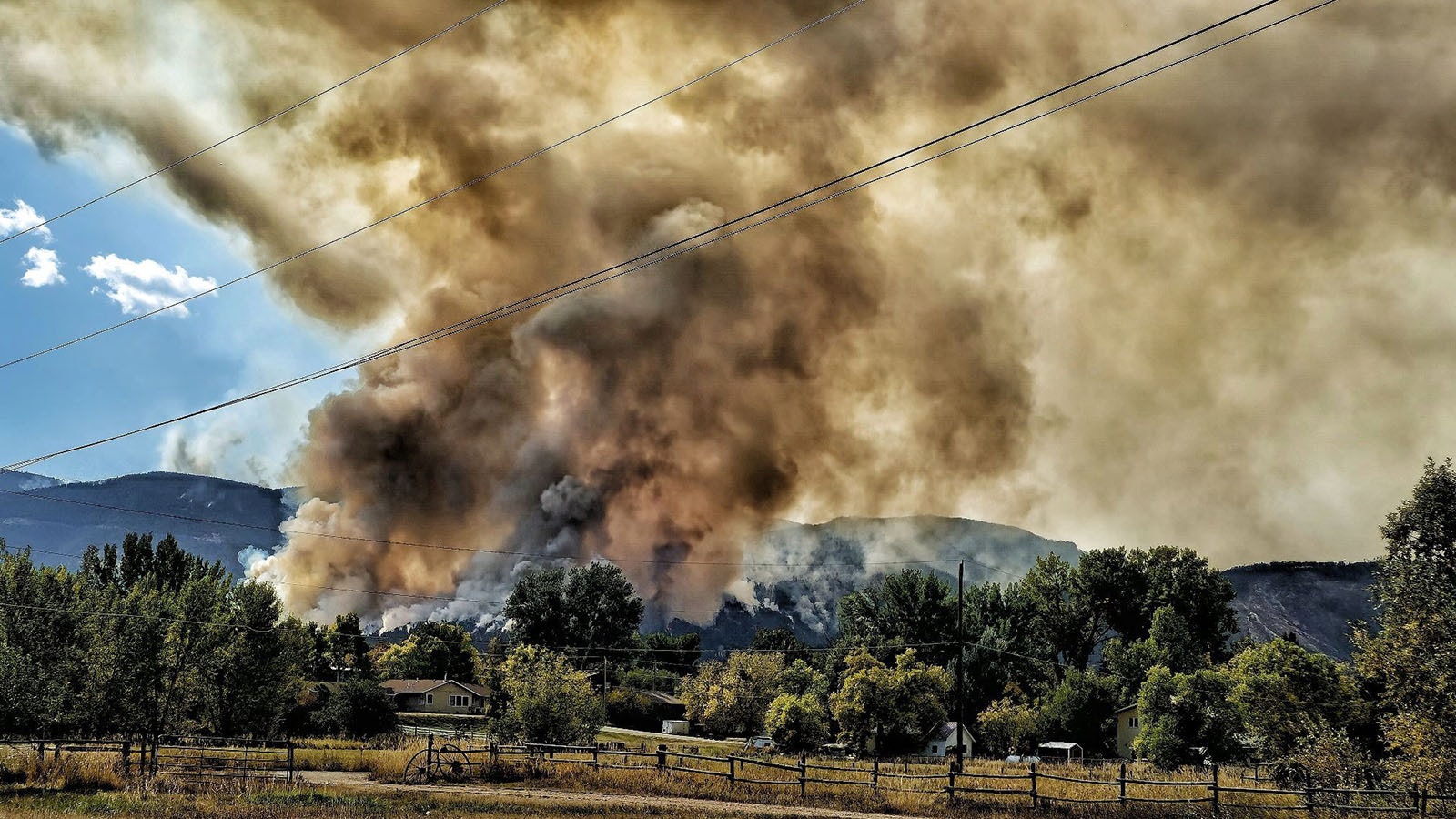 The small, rural Wyoming town of Dayton can only watch and pray as the Elk Fire burns across the mountain face of the Bighorns above.