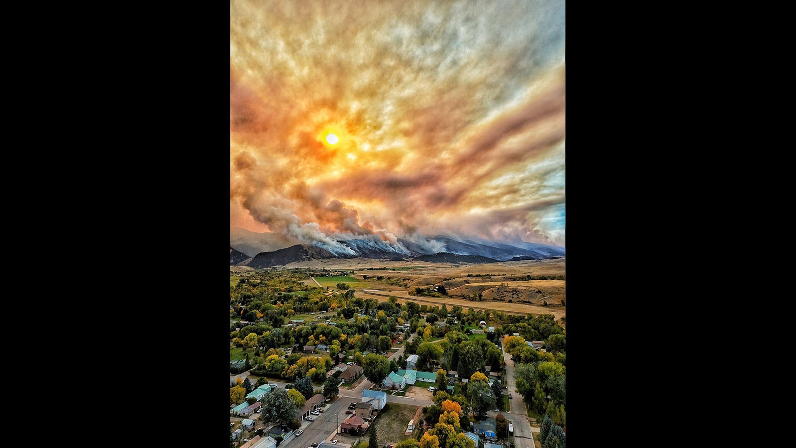 The small, rural Wyoming town of Dayton can only watch and pray as the Elk Fire burns across the mountain face of the Bighorns above.