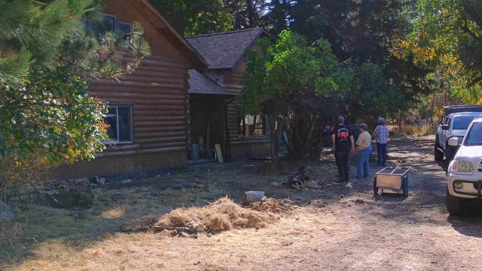 Volunteers take stock of work done to help prepare this home to be defensible from wildfire.