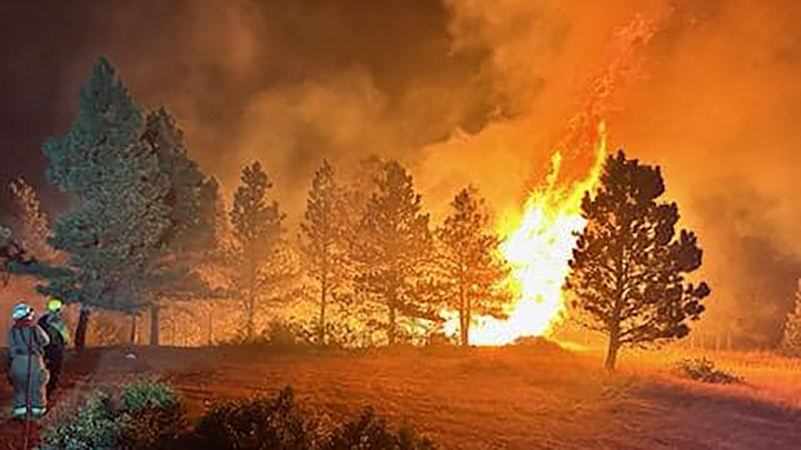 Crews from the Tongue River Fire Distict work to protect people and property from the Elk Fire.