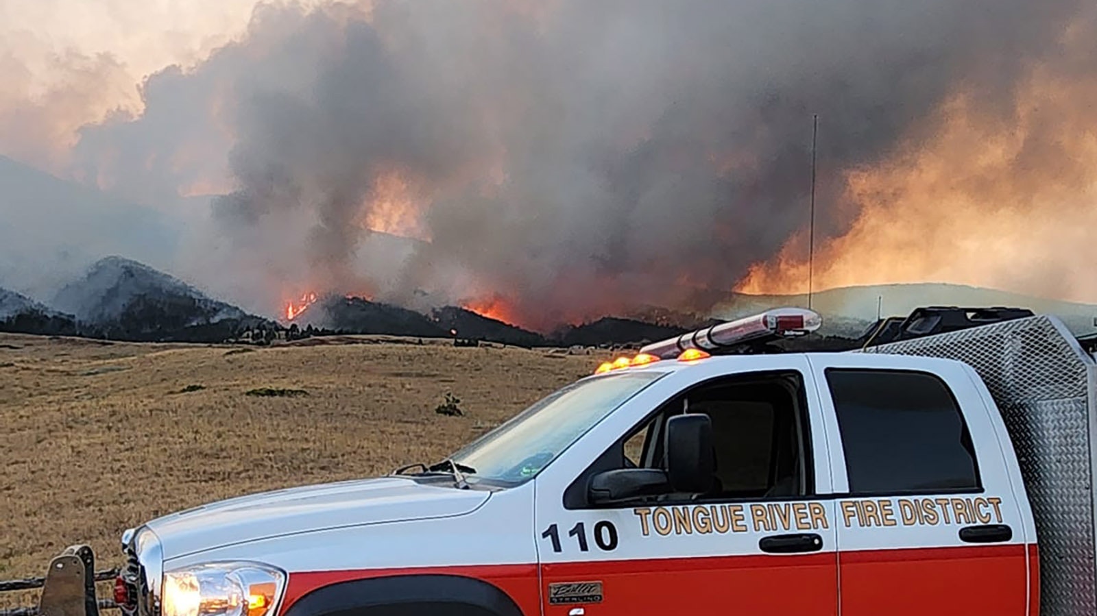 Crews from the Tongue River Fire Distict work to protect people and property from the Elk Fire.