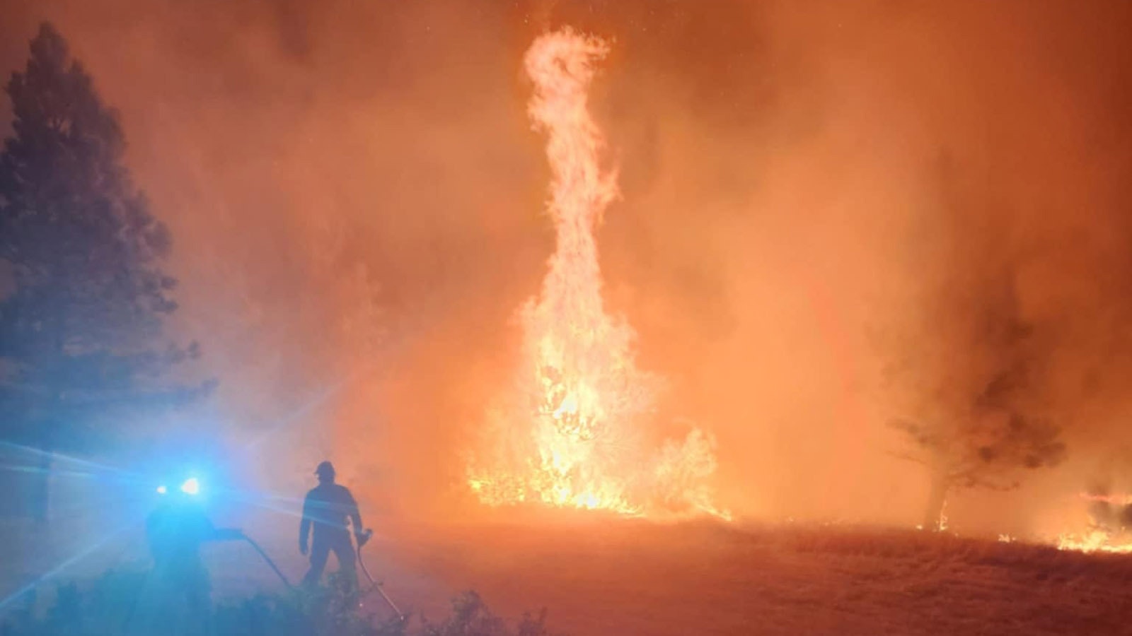 Crews from the Tongue River Fire Distict work to protect people and property from the Elk Fire.