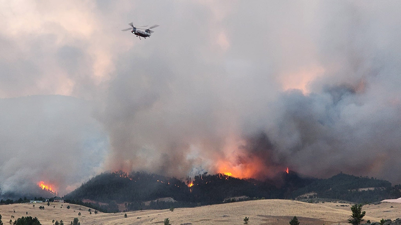 Crews from the Tongue River Fire Distict work to protect people and property from the Elk Fire.