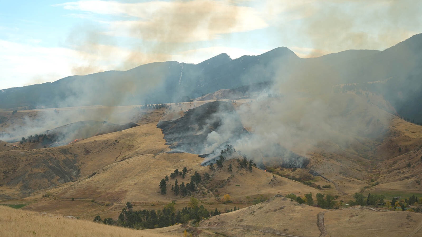 Firefighting crews worked overnight Thursday on back burning operations to battle the Elk Fire in northern Wyoming. Some of those including drones dropping incendiary devices in hard-to-get-to places and created an eerie glow in spots overnight.